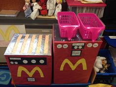 two mcdonald's ovens sitting on top of each other in front of toys