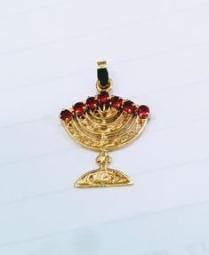 Menorah Pendant, Gold, filigree double sided Menorah , one side red Ruby other side with deep blue sapphire on top the Candles. hamsa ring, hebrew ring, star of david ring, menorah, shema ring, jewish rings, mezuzah necklace, jewish ring, tree of life ring, jewish star ring, israel ring, hamsa rings, star of david, jewish jewelry, jewish antiques, chai pendant, bible verse ring, shema israel ring, chai necklace for men, 1990s star of david ring, Menorah, Spiritual Gold Star Of David Jewelry, Jewish Jewelry Necklaces, Menorah Jewelry, Jewish Necklace, Antique Judaica, Judaica Jewelry, Scripture Jewelry, Jewish Jewelry, Tree Of Life Necklace