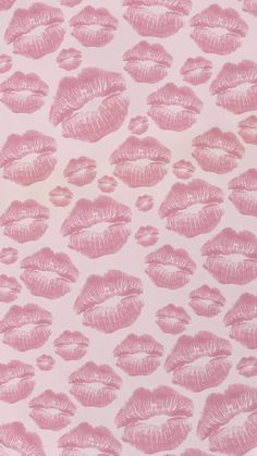 pink lipstick prints on a white background with light pink highlights in the shape of lips