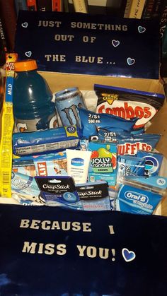 a box filled with snacks and drinks on top of a table