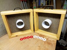 two wooden frames sitting on top of a table