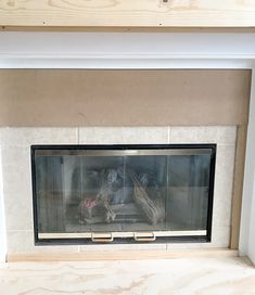 a fireplace with a fire in it sitting on top of a mantle