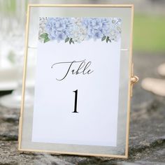 a table number sign with blue flowers on it