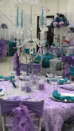 the table is set with purple and teal decorations