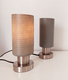 two lamps sitting next to each other on a table