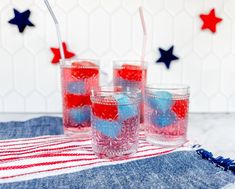 three glasses filled with red, white and blue liquid