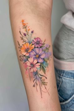 a woman's arm with flowers on it