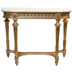 an antique console table with marble top and gold leaf decorations on the legs, against a white background