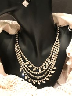 "This is a stunning, vintage, rhinestone, bib necklace. The necklace is in excellent, vintage condition, and is unique and versatile. These necklaces are becoming more and more difficult to find in this condition. Each rhinestone is set, not glued. This one is not missing any stones, and all stones are clear. The necklace is 17\" long, and weighs 52g. The necklace is not signed, but beautifully made." Vintage Diamond Necklace With 17 Jewels For Evening, Dazzling Rhinestone Necklaces For Formal Occasions, Sparkling Crystal Rhinestone Necklace For Evening, Crystal Necklaces With Sparkling Stones For Evening, Crystal Bling Necklace For Evening, Crystal Necklaces For Evening, Crystal Necklace With Sparkling Stones For Evening, Vintage Diamond Necklace For Evening, Vintage Crystal Necklace With Sparkling Stones