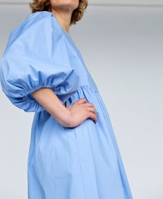 "Puffy sleeve cotton dress in sky blue color. Perfect for any occasion or to wear every day. - Handmade in our studio from 97% cotton 3% spandex - Relaxed fit - Crew neckline - Half-length puffed sleeves - Side slip pockets - Full A-line skirt - Straight, midi hem FABRIC&CARE Cotton Hand wash or gently machine washable 30C, hang dry recommended, iron on reverse. SIZE&FIT Simona is wearing XS size and is 172 cm/5'8\" tall. SIZE XXS *BODY: Bust: fits bust around 32\"-33\"/ 82-84 cm Waist: Blue Cotton Midi Dress With Gathered Sleeves, Cotton Day Dresses With Gathered Sleeves, Cotton Daywear Dress With Gathered Sleeves, Light Blue Long Sleeve Cotton Dress, Cotton Day Out Dress With Gathered Sleeves, Blue Cotton Dress With Gathered Sleeves, Cotton Dress With Gathered Sleeves For Day Out, Blue Cotton Mini Dress, Blue Cotton Puff Sleeve Dress With Gathered Sleeves