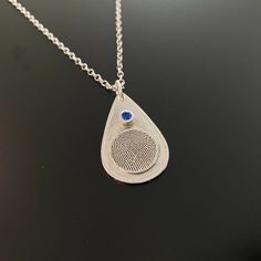 "ABOUT THIS LISTING: Fingerprint Jewelry is uniquely personal and a constant reminder of your loved ones .... past or present. This teardrop shape pendant is approximately 1\" and includes a 3mm birthstone CZ set in a sterling silver bezel and a raised 1/2 inch fingerprint disk. We can add custom text or actual handwriting on the back side. Also available is a Rolo Style, 18\" Sterling Silver Chain with lobster clasp. ORDER OPTIONS: Teardrop Shaped Pendant with CZ Birthstone: $215.00 Pendant wit Silver Teardrop Pendant Birthstone Necklace, Silver Teardrop Sterling Silver Birthstone Necklace, Silver Teardrop Gemstone Birthstone Necklace, Sterling Silver Teardrop Birthstone Necklace Gift, Silver Teardrop Birthstone Necklace For Gift, Silver Teardrop Birthstone Necklace, Sterling Silver Teardrop Necklace With Bezel Setting, Teardrop Sterling Silver Keepsake Jewelry, Sterling Silver Teardrop Keepsake Jewelry