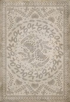 a beige and white rug with an intricate design