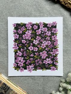 purple flowers are arranged on a black and white background, with green leaves in the middle