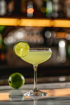 a lime margarita sitting on top of a table