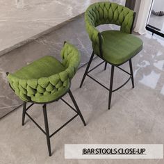 two green chairs sitting next to each other on top of a marble flooring area