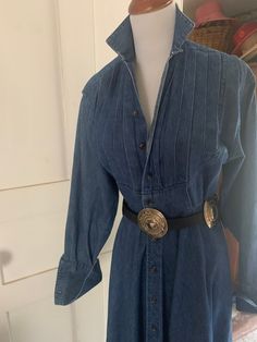 Gorgeous vintage Ralph Lauren label size 4 denim dress with full seeep skirt up to 54-55 inches! Bib style tuxedo front. Button up bodice with metal hook clasp at waist.  Slightly full dolman style sleeves with gold back cuffs that are meant for your cuff links! Belt loops but no belt included.  Belt shown not included.  The dress would fit most likely  to a 34-35" bust l but it has a 23" to 24" max waistline. Full sweep 54-55 inch hemline. Measures 49"  from shoulder to hem.  cuffs felley exten Classic Fitted Denim Dress For Fall, Fitted Classic Denim Dress For Fall, Classic Fitted Denim Dress With Buttons, Fitted Long Sleeve Dress With Pintucks, Vintage Long Sleeve Blue Denim Dress, Classic Fitted Denim Dress, Elegant Denim Daywear Dress, Elegant Denim Dress For Daywear, Classic Denim Dress With Buttons