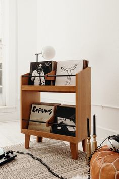 a living room filled with furniture and a tv on top of a wooden stand in front of a window