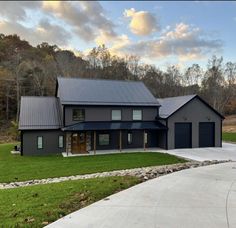 this is an image of a modern house in the country side with grass and trees