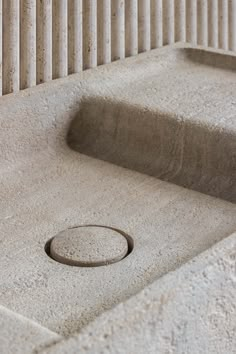 a concrete sink with a drain in the middle and steps leading up to it on either side