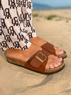 Adorn your feet with effortless style when you don this buckle slide that is ideal for your warm weather attire. Slip-on / buckle closure Man-made upper Cushioned footbed cushioned EVA sole Casual Slip-on Slides With Tang Buckle, Casual Tang Buckle Slip-on Slides, Flat Heel Footbed Sandals With Buckle Closure For Vacation, Beach Slides With Tang Buckle And Round Toe, Flat Heel Footbed Sandals With Buckle Closure For Beach, Closed Toe Footbed Sandals With Buckle For Vacation, Slip-on Sandals With Tang Buckle For Beach, Casual Spring Slides With Tang Buckle, Beach Slides With Tang Buckle