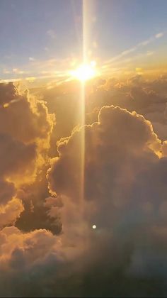 the sun shines brightly through clouds in this photo taken from an airplane's window