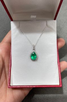 "An absolutely stunning, natural pear Emerald and diamond halo pendant in 14K white gold. The center stone is a Colombian Emerald pear of fine quality, the emerald has incredible green color and very good eye clarity. Any small imperfections are completely normal in natural stones. There are an estimated 1/2ct of high-quality diamonds surrounding the center stone in a delicate halo style. Setting Style: Halo Cluster Setting Material: 18k White Gold / Chain 18\" 18K Main Stone: Emerald Shape: Pea White Gold Pear-shaped Emerald Jewelry, Pear-shaped Emerald Necklace In White Gold For Anniversary, Anniversary White Gold Pear-shaped Emerald Necklace, Emerald Diamond Necklace With Brilliant Cut Pear-shaped, Fine Jewelry Emerald Necklace With Pear Gemstone, Fine Jewelry Pear-shaped Emerald Necklace For Anniversary, Green Pave Setting Jewelry For Gift, Pear-shaped Emerald Necklace In Fine Jewelry Style, Pear-shaped Emerald Necklace May Birthstone