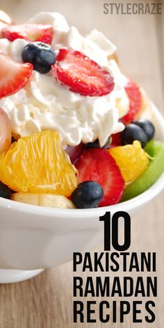 a bowl filled with fruit and whipped cream on top of a wooden table in front of the words, 10 pakistan ramadan recipes