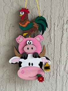 a cow and chicken hanging on a wall