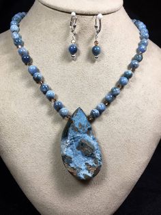 "Gorgeous pear-shaped Chrysocolla Druzy is the focal point of this beautiful 20\" necklace on a strand of natural blue Apatite beads. With a sterling clasp and matching lever back earrings. A natural Beauty! I use only the highest quality components for my beadwork. Colors may differ slightly due to various monitors. 7-day return policy. Than you for looking!" Chrysocolla Gemstone Teardrop Necklace, Blue Apatite, Focal Bead, Jewelry Designs, Pear Shaped, Druzy, Focal Point, Bead Work, Diy Jewelry