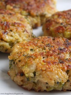 four crab cakes on a white plate ready to be eaten