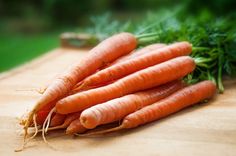 some carrots are sitting on a cutting board