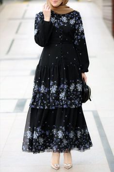 The Maiyah Modest Dress from Annah Hariri is a beautiful and elegant piece that is perfect for special occasions or everyday wear. The dress features a gorgeous ruffled design and an eye-catching print that will make you stand out from the crowd. The front fastening features many buttons for added detail and the cuffed buttoned sleeves provide a touch of sophistication. Made from polyester chiffon fabric with a cotton lining, this dress is both comfortable and breathable Care is easy with normal Golden Prom Dress, Dresses Islamic, Velvet Abaya, Abaya Dress Muslim, Turkish Dresses, Abaya Dresses, Cotton Hijab, Modest Activewear, Abaya Design