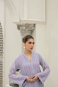 Introducing our stunning Lavender chiffon embroidered shirt hand-worked and embellished with minute mirror work details. Paired with matching raw-silk pants. This elegant dress is adorned with intricate details, featuring beautiful embroidery and embellishments. Elegant V-neck Salwar Kameez With Dabka Work, Designer Wear Elegant V-neck Salwar Kameez, Long Sleeve Party Wear Kurta With Mirror Work, Party Wear Kurta With Mirror Work, Elegant Festive Kurta With Sequins, Elegant V-neck Kurta With Dabka Work, Party Wear Long Sleeve Kurta With Mirror Work, Elegant Sequined Kurta For Eid, Eid Georgette Blouse With Mirror Work