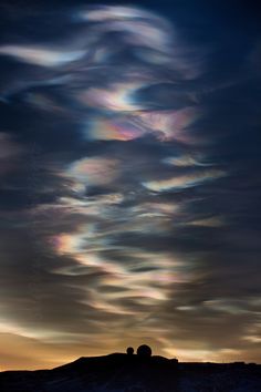 the sky is filled with swirling clouds at sunset