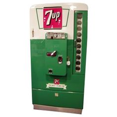 an old style vending machine with 7 up on top