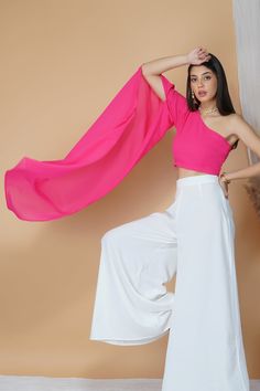 Elevate your appeal this summer with a rather classy yet stunning contrasting crop top and pants set. With a one-shoulder flared style crop top and relaxed pants, this set is ideal to be worn for weekend getaways, formal events, lunches and even evening galas.Style One shoulder sleeves Pink hued crop top White tailored pants Georgette fabric Specifications Model height - 5'7" Model wearing - S White Tailored Pants, Georgette Crop Top, Crop Top And Pants Set, Crop Top And Pants, Relaxed Pants, Style Crop Top, Top And Pants Set, Pink Crop Top, Georgette Fabric