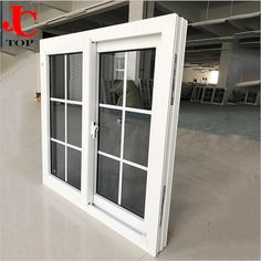 an open window in the middle of a room with white walls and windows on each side