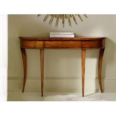 a wooden table with a book on it and a sun decoration above the top shelf