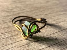 a green ring sitting on top of a wooden table