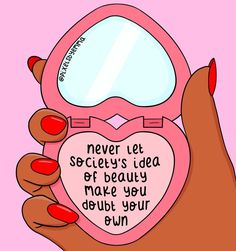 a woman's hand holding a pink heart shaped mirror with words written on it