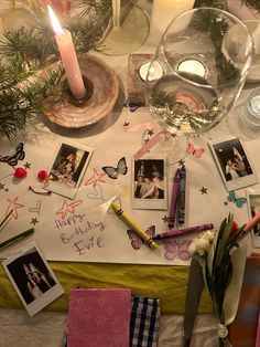 a table topped with pictures and candles