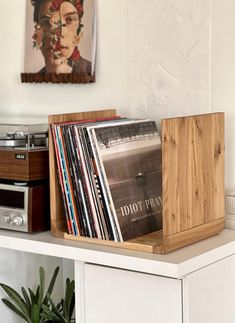 a record player sitting on top of a white shelf