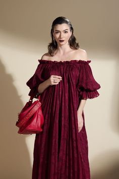 Expertly crafted with a stunning brocade fabric, this dress is a timeless piece that exudes elegance. Its unique gathered pleated design is both stylish and flattering, making it a versatile addition to any wardrobe. The freesize fit ensures a comfortable and effortless fit for any body shape. Luxury Red Brocade Dresses, Flowy Red Pleated Maxi Dress, Flowy V-neck Maxi Dress With Pleated Waist, Luxury V-neck Maxi Dress With Pleated Bodice, Capsule Dressing, Luxury Red Brocade Embroidered Fabric, Brocade Fabric, Designer Collection, Timeless Pieces