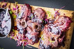 steaks with blueberry sauce on a cutting board