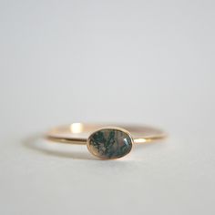 Beautiful oval moss agate ring. Small 6x4mm natural moss agate stone. It is a beautiful clear to milky with green filaments that resemble moss. The band is thin at 1mm. Polished for a beautiful shine finish.  *MATERIAL OPTIONS- -Sterling Silver -14k Gold Filled -14k Solid (Yellow) Gold -14k Solid Rose Gold -14k Solid White Gold Made to order in your size. Sizes in drop down box are U.S. ring size.  I really want you to be happy with your purchase. If you have any questions or concerns please jus Oval Ring Gold, Minimalist Jewelry Rings, Green Gemstone Ring, Moss Agate Ring, Ringe Gold, Minimal Jewelry, Ring Minimalist, Agate Ring, Ring Dainty