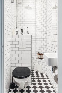 a bathroom with black and white tile flooring