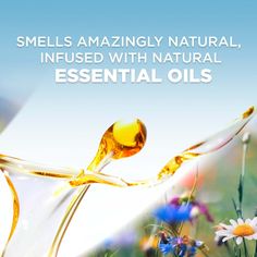 an advertisement for essential oils with flowers in the foreground and text that reads smells amazingly natural, infused with natural essential oils