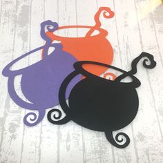 three silhouettes of teapots sitting on top of a wooden table next to each other