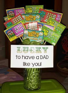 a green vase filled with lots of cards next to a sign that says lucky to have a dad like you