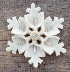 a white snowflake sitting on top of a wooden table